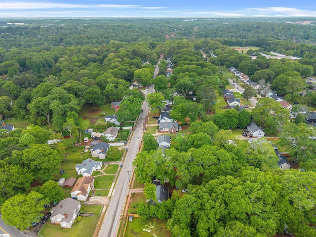 drone / aerial view with a residential view and a wooded view