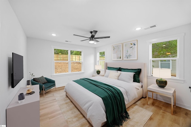 bedroom featuring baseboards, visible vents, and light wood-style flooring