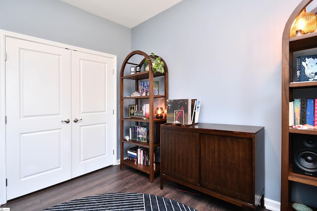 interior space with dark wood-style floors and arched walkways