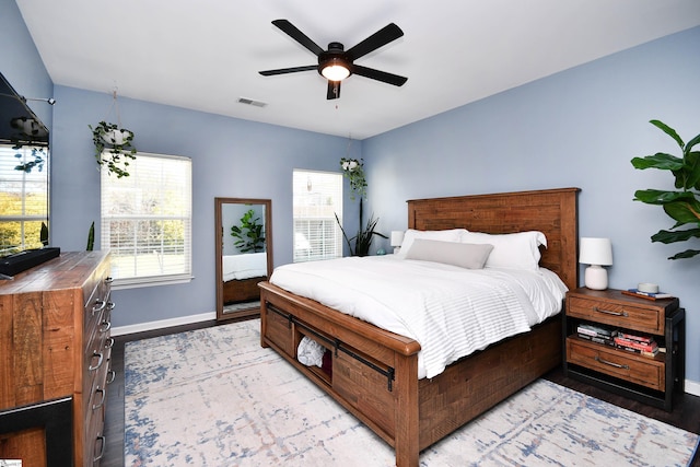 bedroom featuring baseboards, visible vents, a ceiling fan, and light wood-style floors