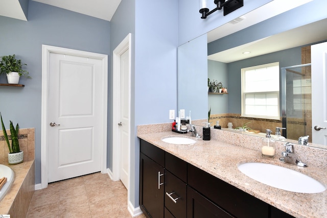 full bath with a bath, double vanity, a sink, and a shower stall
