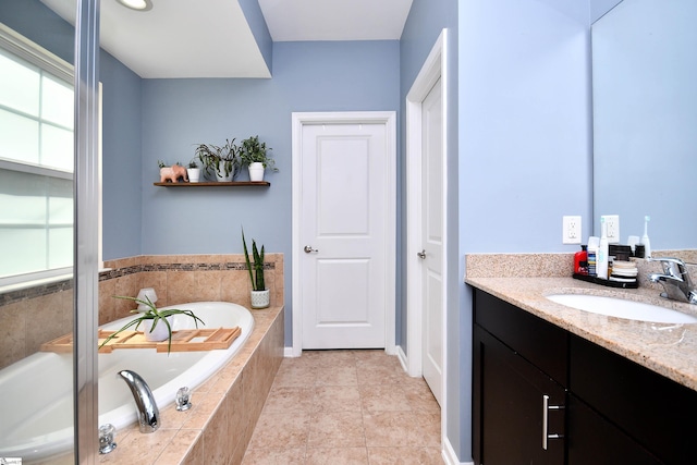 full bathroom featuring a bath and vanity