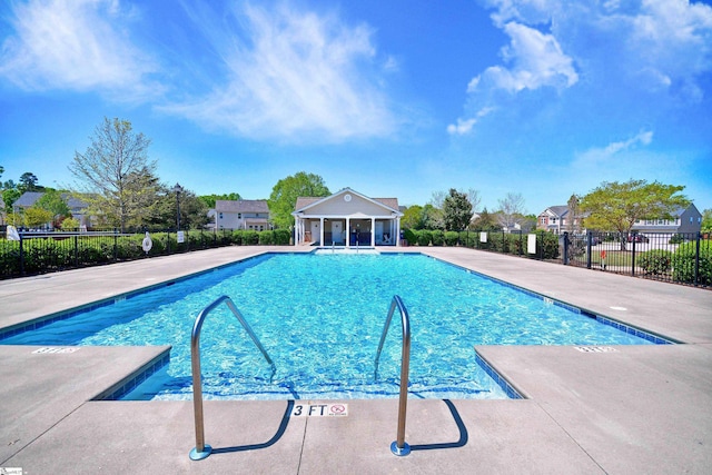 community pool featuring a patio area and fence