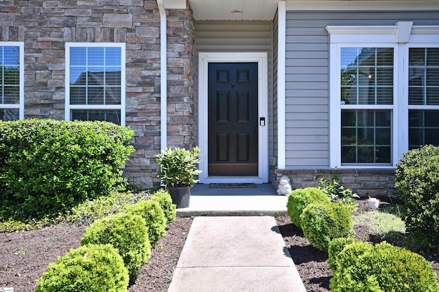 doorway to property featuring stone siding