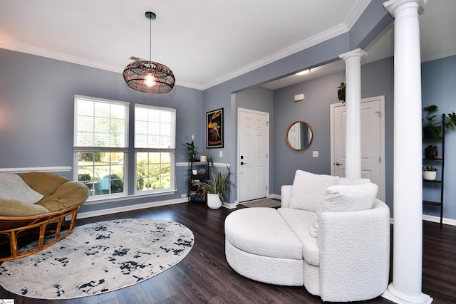 living area with baseboards, ornate columns, wood finished floors, and ornamental molding