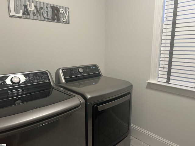 laundry area with washer and dryer, laundry area, and baseboards