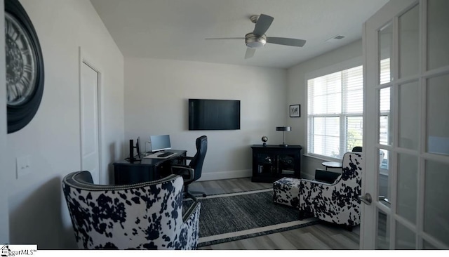 office area featuring wood finished floors, ceiling fan, and baseboards