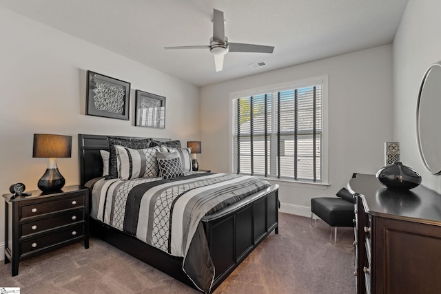 carpeted bedroom featuring baseboards, visible vents, and ceiling fan