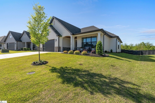 view of front of home with a front yard, board and batten siding, concrete driveway, an attached garage, and fence