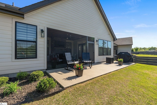 back of property featuring fence, a yard, and a patio area