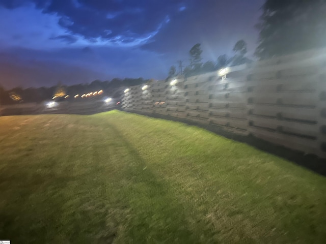 view of yard at twilight