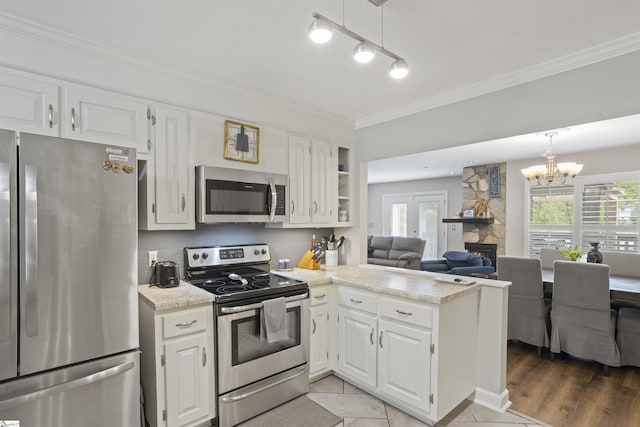 2 Graystone Way, Taylors, SC 29687 - kitchen featuring white cabinets, stainless steel appliances, open floor plan, a peninsula, and backsplash