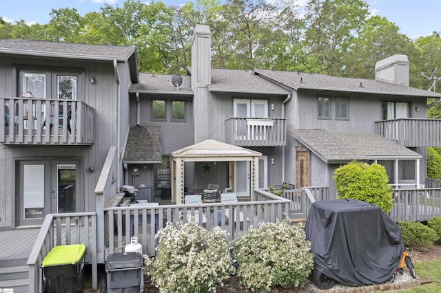2 Graystone Way, Taylors, SC 29687 - back of property with a balcony, a wooden deck, a chimney, a shingled roof, and french doors