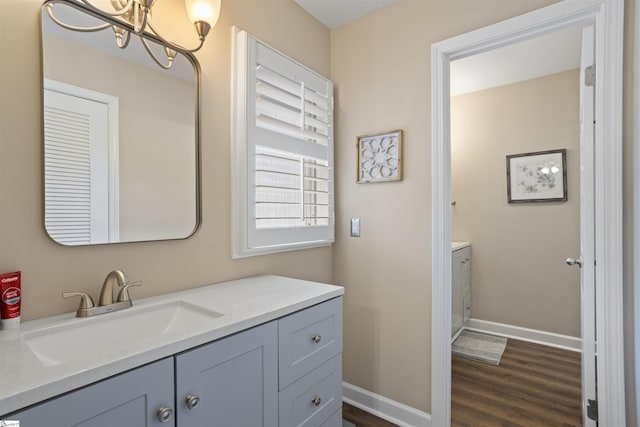 2 Graystone Way, Taylors, SC 29687 - bathroom featuring baseboards, wood finished floors, a notable chandelier, and vanity
