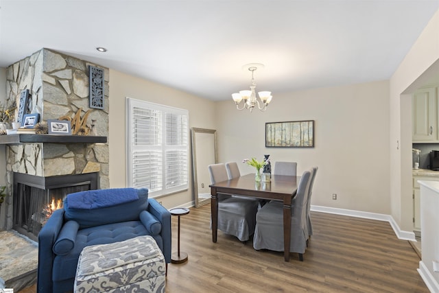 2 Graystone Way, Taylors, SC 29687 - dining area with wood finished floors, a notable chandelier, a stone fireplace, and baseboards