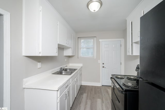 kitchen featuring a sink, light wood-type flooring, black appliances, light countertops, and white cabinets