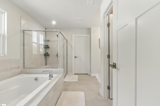 229 Hollythorpe Ln, Fountain Inn, SC 29644 - bathroom featuring a garden tub, a shower stall, tile patterned floors, and baseboards