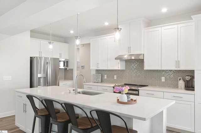 229 Hollythorpe Ln, Fountain Inn, SC 29644 - kitchen with a kitchen breakfast bar, a sink, stainless steel appliances, under cabinet range hood, and a kitchen island with sink