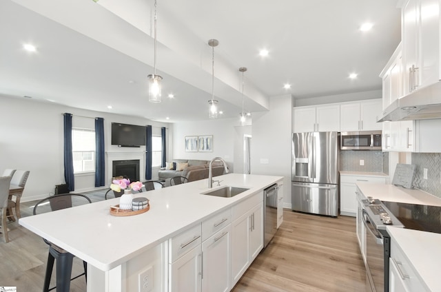 229 Hollythorpe Ln, Fountain Inn, SC 29644 - kitchen with recessed lighting, decorative backsplash, stainless steel appliances, a sink, and a center island with sink