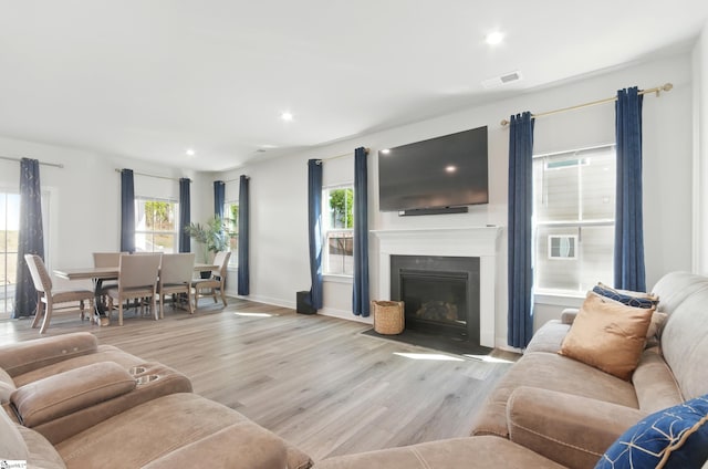 229 Hollythorpe Ln, Fountain Inn, SC 29644 - living area with a fireplace with flush hearth, visible vents, baseboards, recessed lighting, and light wood finished floors