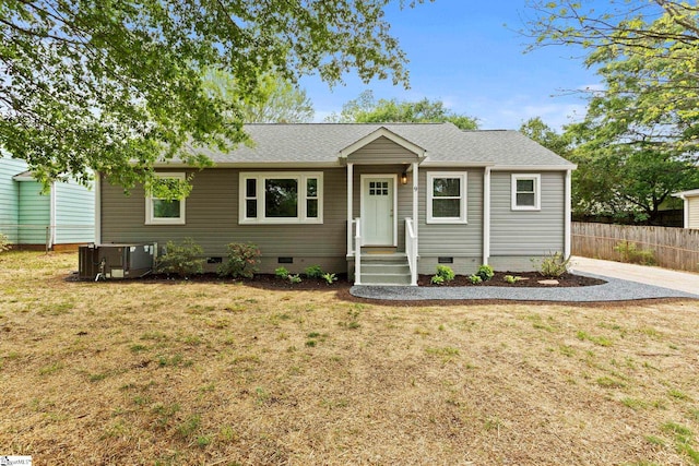 single story home featuring a front yard, central air condition unit, crawl space, and fence