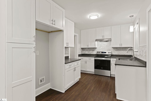 kitchen with a sink, dark countertops, dark wood-type flooring, and stainless steel electric range