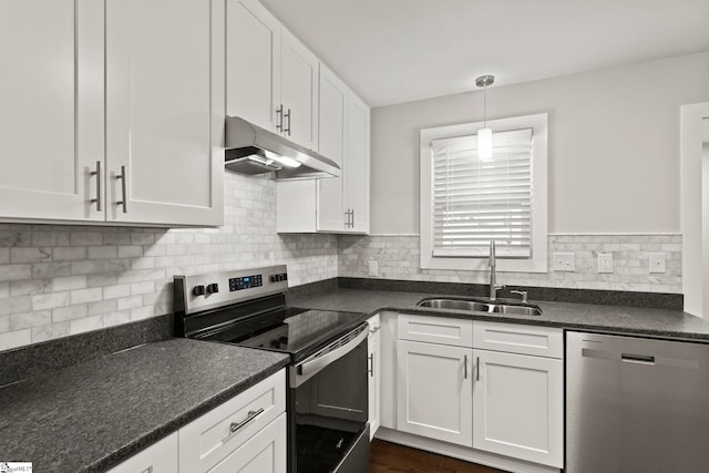 kitchen featuring under cabinet range hood, appliances with stainless steel finishes, white cabinets, backsplash, and a sink