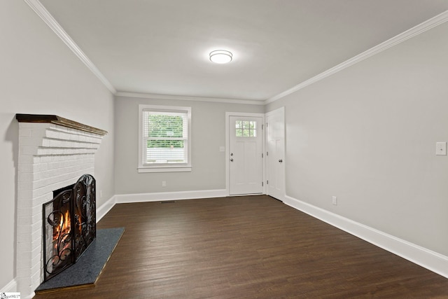 unfurnished living room with ornamental molding, a brick fireplace, baseboards, and dark wood finished floors