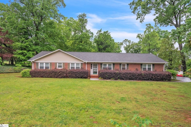 single story home featuring a front lawn and brick siding