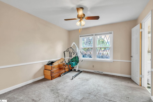 workout room featuring visible vents, ceiling fan, carpet, and baseboards