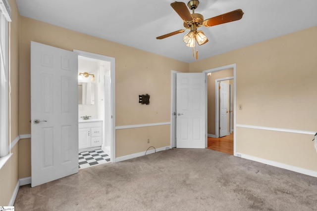 unfurnished bedroom featuring carpet flooring, ensuite bath, and baseboards