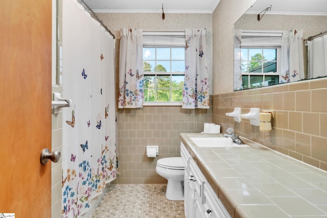 bathroom featuring a healthy amount of sunlight, toilet, tile patterned flooring, and vanity