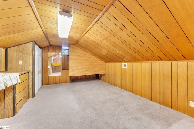 bonus room with lofted ceiling, wooden walls, carpet flooring, and wooden ceiling