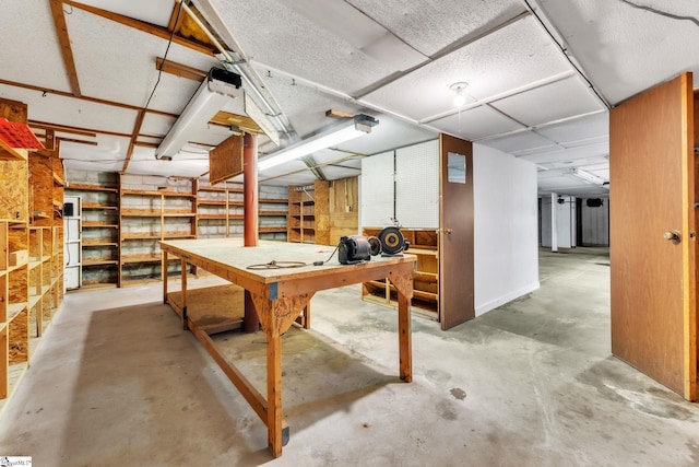unfinished basement with a workshop area