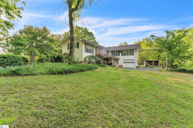 view of front of house with a front lawn, driveway, and an attached garage