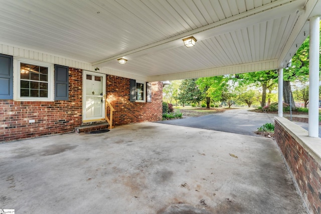 view of patio with driveway and an attached carport