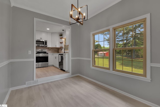 kitchen with stainless steel appliances, decorative backsplash, a notable chandelier, visible vents, and light countertops