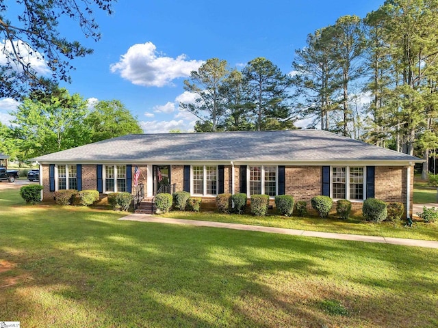 ranch-style house with brick siding and a front lawn