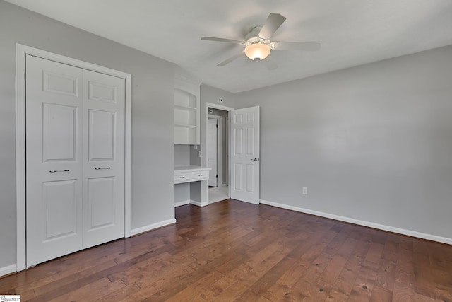 unfurnished bedroom featuring dark wood-style floors, baseboards, and ceiling fan