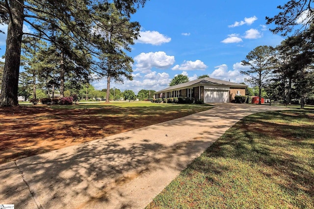 view of front of house featuring brick siding, concrete driveway, a front yard, and an attached garage