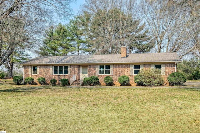 single story home with a front lawn, brick siding, and a chimney