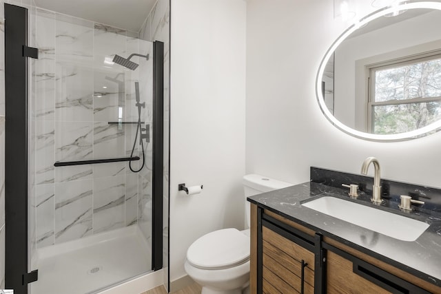full bathroom with a marble finish shower, toilet, and vanity