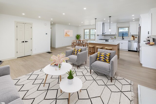living area featuring recessed lighting and light wood-style floors