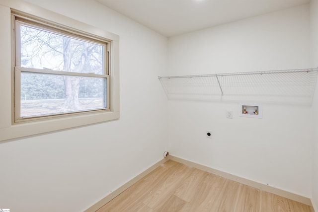 laundry area with hookup for an electric dryer, laundry area, light wood-type flooring, hookup for a washing machine, and baseboards
