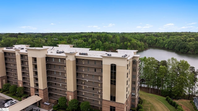 view of property featuring a forest view and a water view