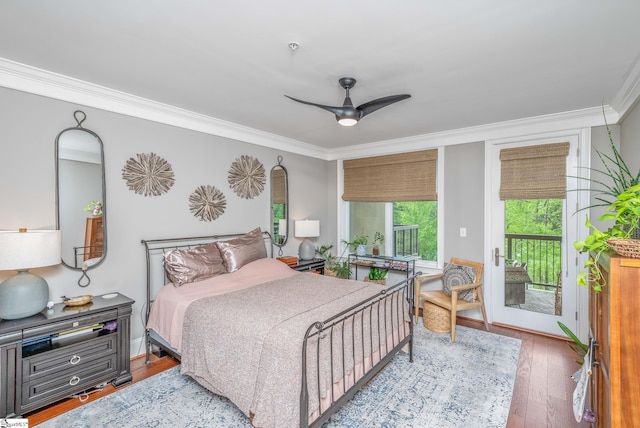 bedroom featuring a ceiling fan, wood finished floors, crown molding, and access to exterior