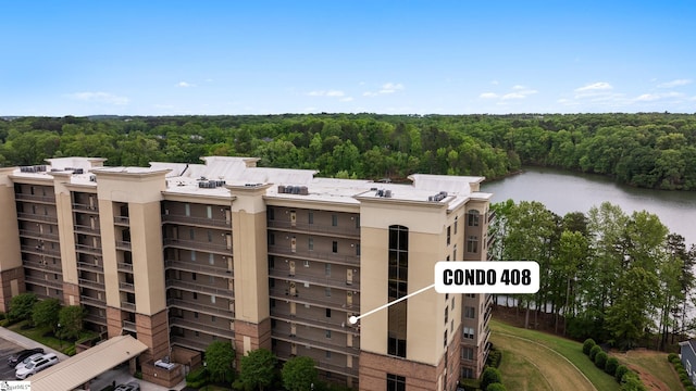 view of building exterior with a water view and a view of trees