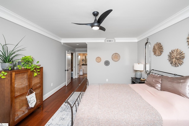 bedroom with ornamental molding, visible vents, wood finished floors, and baseboards