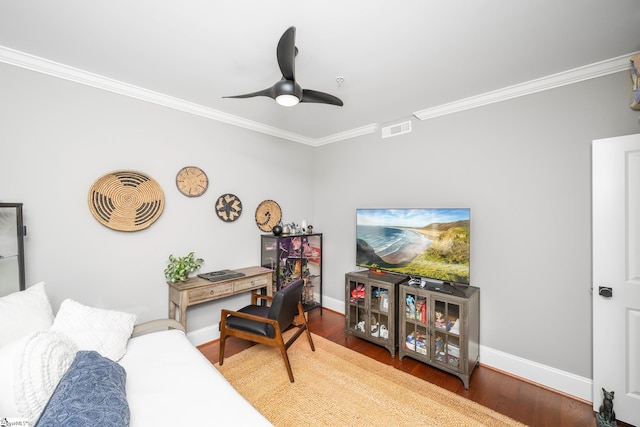office area featuring baseboards, visible vents, ceiling fan, and crown molding
