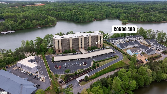 birds eye view of property featuring a water view and a forest view